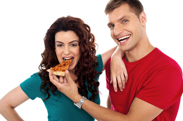 Boyfriend making her girl eat hot pizza piece