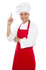 Happy smiling chef showing index finger