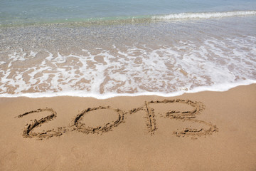 2013 year wrote on the beach, with copy space