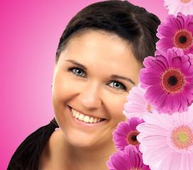 Portrait of a young brunette woman with flowers