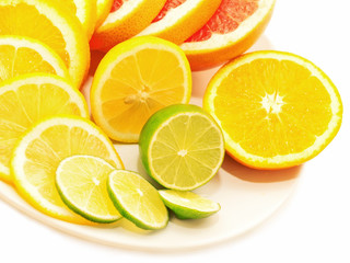 Fototapeta na wymiar Ripe citrus slices on plate isolated on white