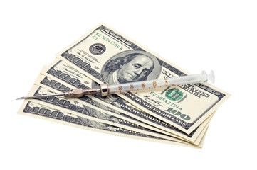 photo of a medical syringe and paper money