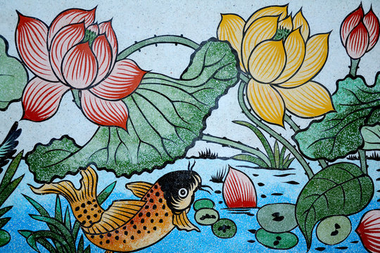 Fish of Wealth and Lotus painting on stone wall.