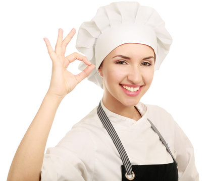 Attractive cook woman showing ok over white background