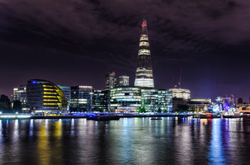 London skyline with lights reflecting from the Thames River