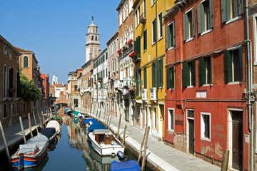 Canal and beautiful sunlit buildings in Venice.
