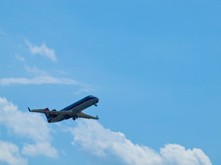 A Commercial Airliner Taking Off into a Partly Cloudy Blue Sky