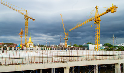 Construction site with crane near building on Cloudy storm backg