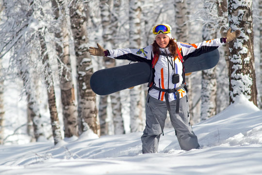 Sport women going for freeride with snowboard