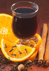 Mulled wine with orange and spices on the table