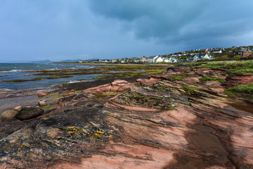 Fototapeta na wymiar City at the rough coastline of Scotland
