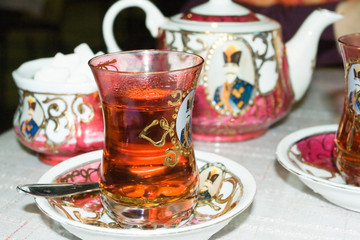 A glass of fresh and hot tea in the Arab style.