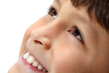 Close-up of young boy's eyes smiling