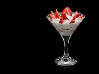Strawberry with cream in a glass.
