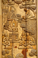 Native Thai style carving, painting on church door in the temple