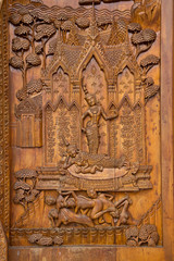 Native Thai style carving, painting on church door in the temple