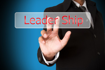 business hand pushing the leader ship  virtual button as concept