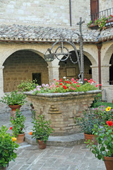 ancient medieval pit for water harvesting with flower pots
