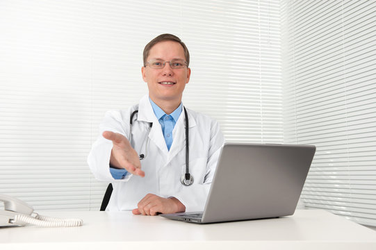 Caucasian doctor with a computer