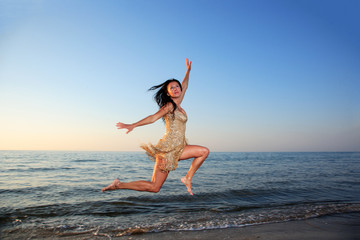 Young woman jumping on a beach