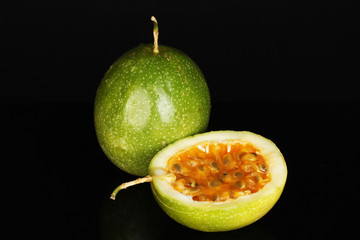 green passion fruit isolated on black background