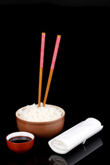 Bowl of rice and chopsticks isoalted on black