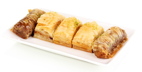 Sweet baklava on plate isolated on white