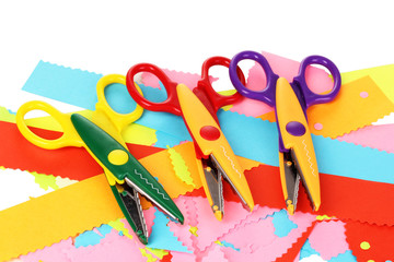 Colorful zigzag scissors with color paper isolated on white