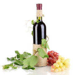 bottle of wine with grape leaves isolated on white