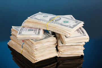 Stacks of dollars on blue background