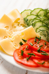 Fresh tomatoes, cucmber and cheese on a plate