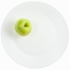 yellow green apple on white plate