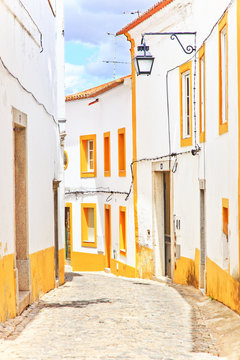 Old urban street and white facades in Evora. Alentejo, Portugal