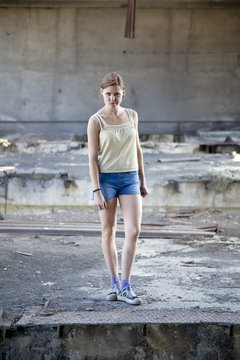 Young beautiful woman in an abandoned old wrecked building