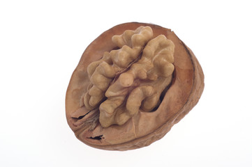 Walnuts, one broken walnut on a white background
