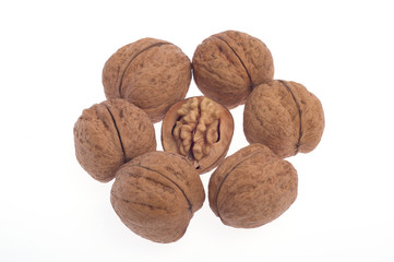 Walnuts, one broken walnut on a white background