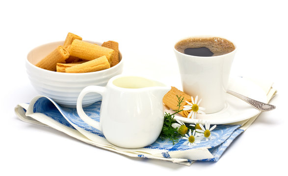Cup of coffee with milk and cookies isolated on white