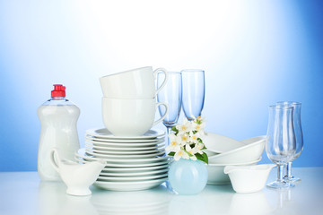 empty clean plates, glasses and cups with dishwashing liquid