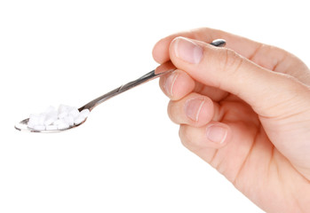 Sweetener in metal spoon isolated on white