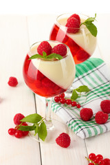 fruit jelly with berries in glasses on wooden table