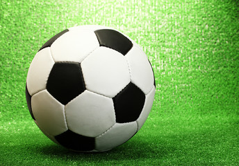 Fototapeta na wymiar football ball on artificial green grass