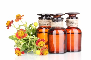 medicine bottles and flowers isolated on white