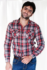 portrait of a happy man wearing checkered shirt