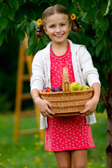 Autumn orchard - lovely girl with ripe fruits in basket