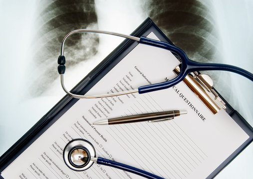 Stethoscope and medical questionnaire on X-ray photo