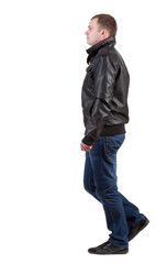 Fototapeta premium Back view of walking handsome man