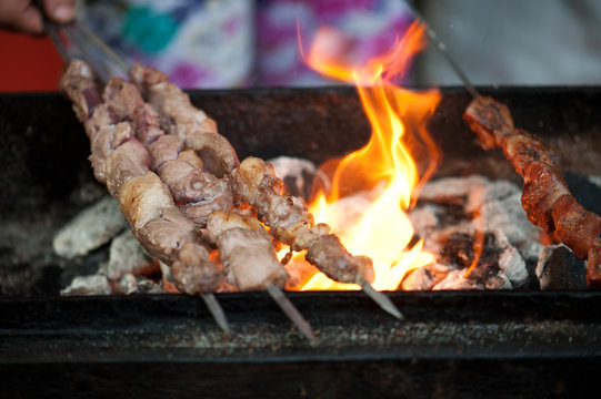 Flames grilling skewers at a market in Xian, China