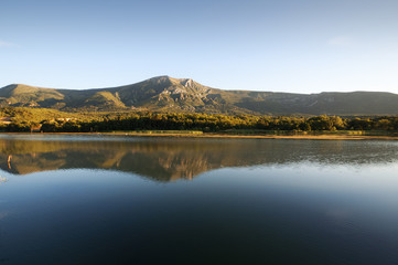 Reflections in the reservoir water at the sunset