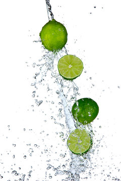 Fresh limes with water splash, isolated on white background