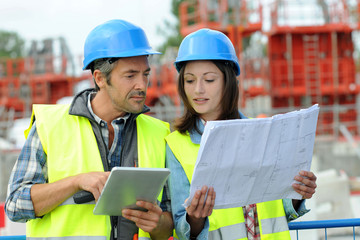 Engineers on building site controlling project